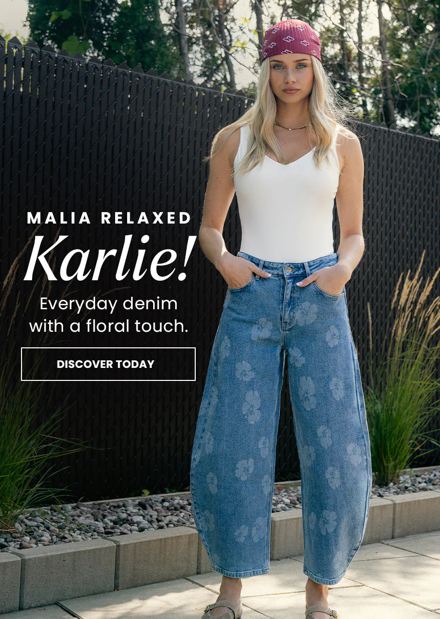 Woman wearing a white tank top and blue floral jeans with text promoting 'Malia Relaxed Karlie' denim.